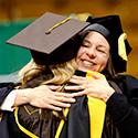 Nursing faculty member hugs graduating student