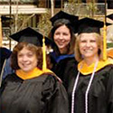 Three nursing faculty in academic regalia