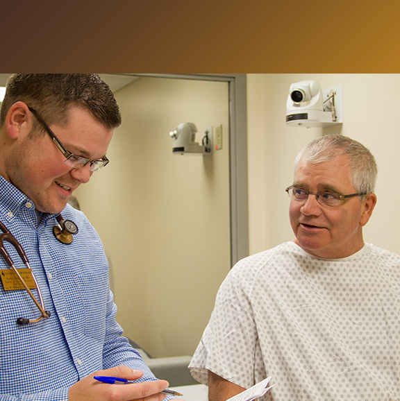 DNP student meets with a standardized patient in the CSC Exam Rooms for the DNP Program