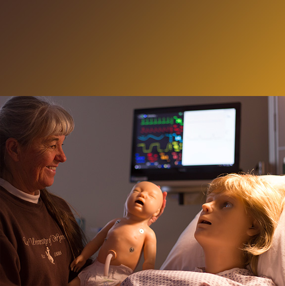 Nursing Staff poses with OB simulators, Noelle and Baby Hal