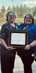 rosa and kaitlyn pictured with award