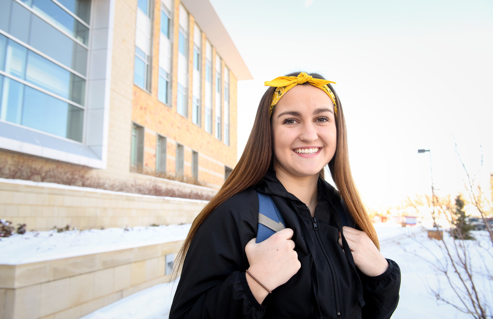 a student stands outside on campus