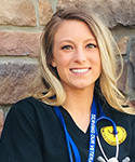 Nichole Paulson posing in her UW nursing scrubs at her capstone location