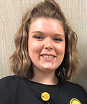 smiling young woman in black nursing uniform