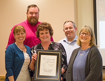 five individuals--two men, three women, receive award plaque for Banner Health Wheatland