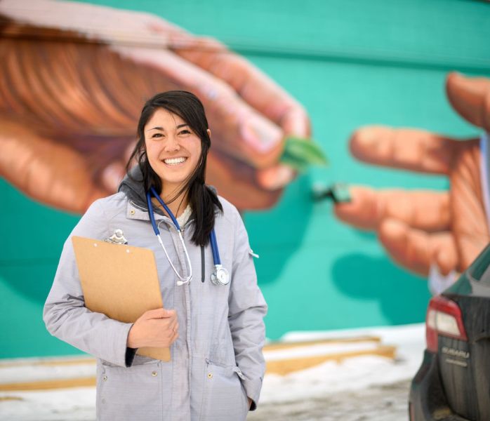 nursing student standing in front of mural downtown laramie