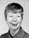 woman with very short hair, professional suit with high collar, black and white picture