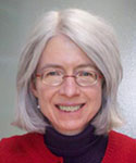 woman with silver hair and blue suit