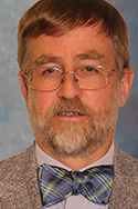 man with beard and glasses in suit