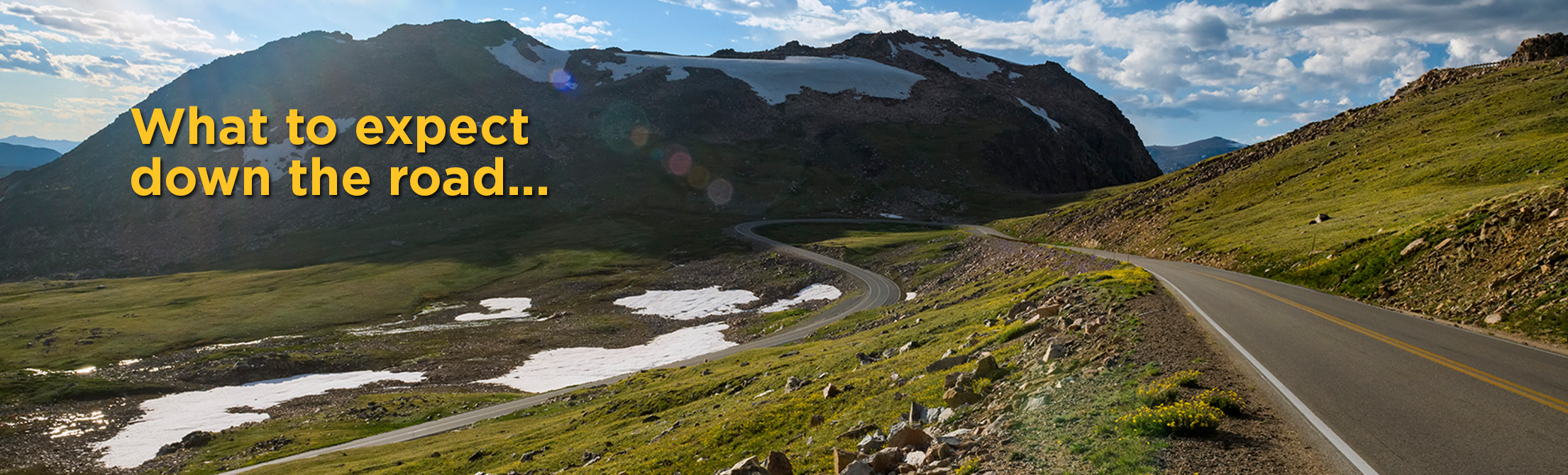 picture of road curving by mountain