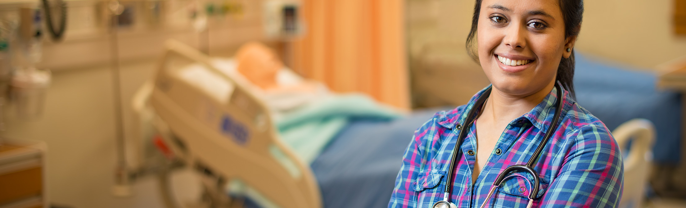 DNP student Kanti Devkota stands in the Skills Lab at the University of Wyoming School of Nursing's Clinical Simulation Center