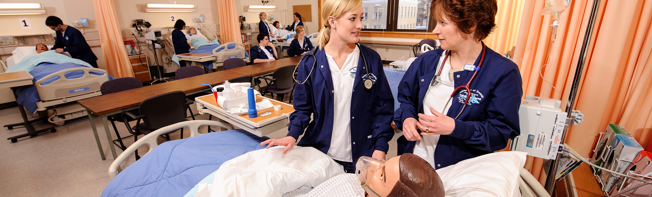 Students working with simulated patients in clinical skills lab