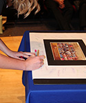 a nursing student signs the Nightingale Pledge poster
