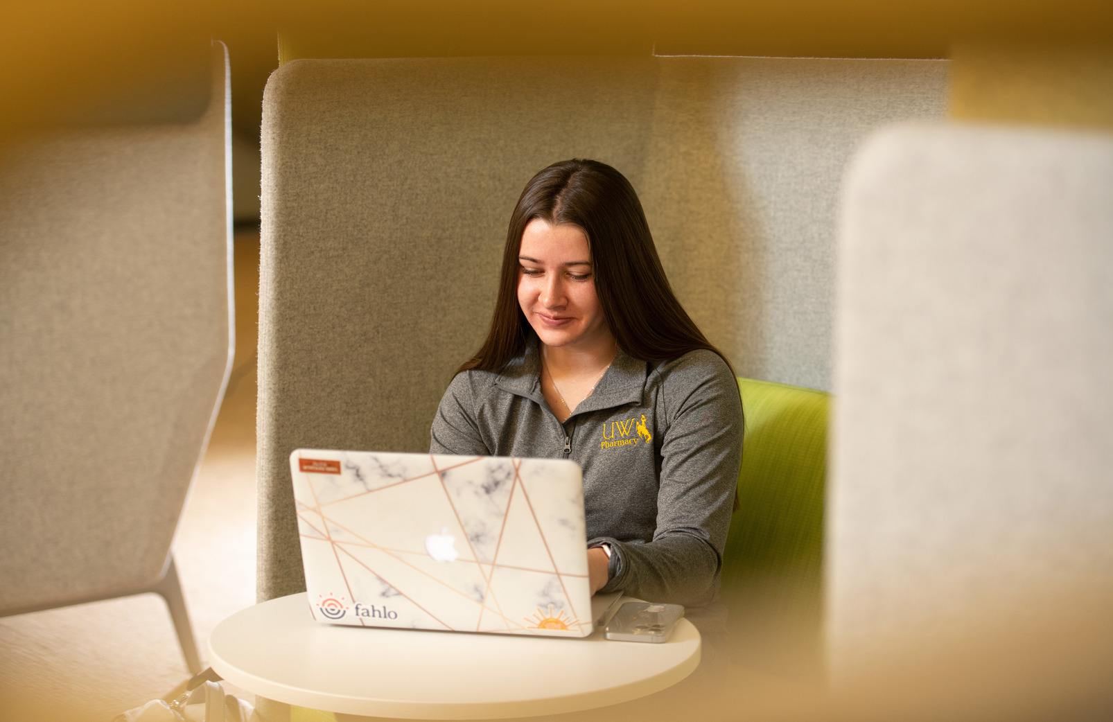 student with a laptop in a study space