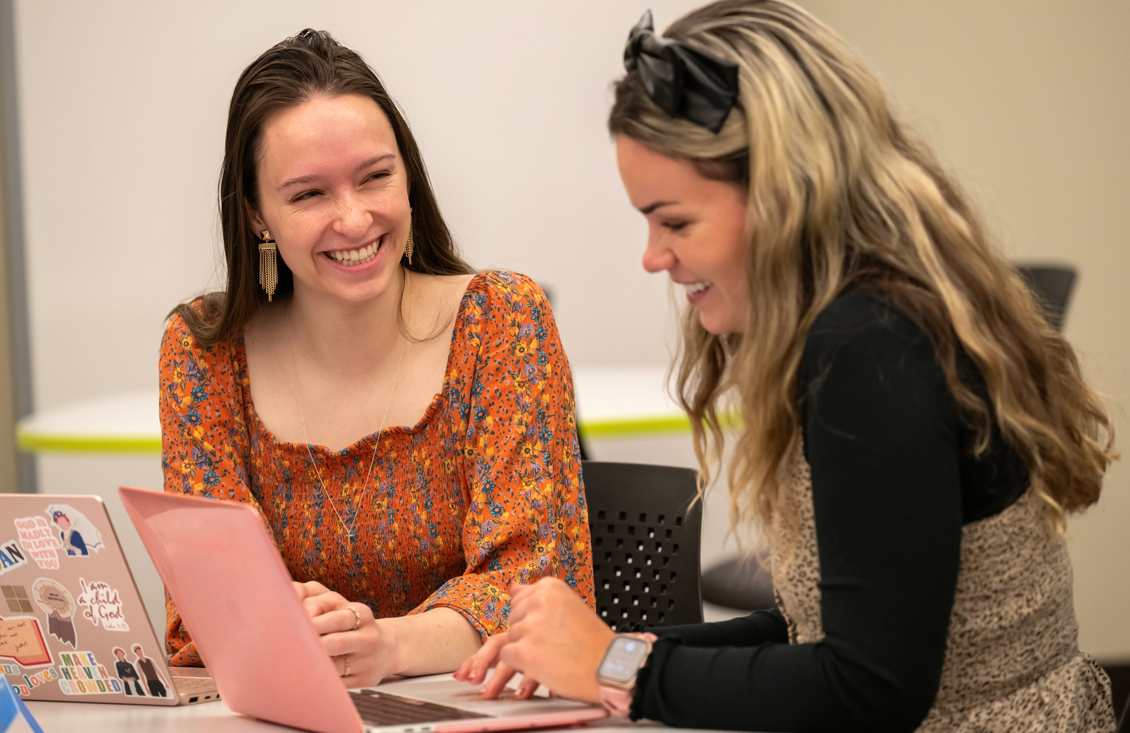 a student works with a staff member