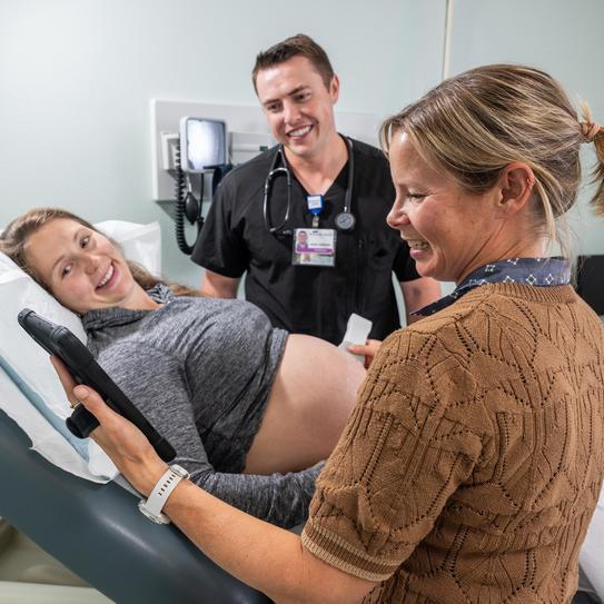 nurse gives an ultrasound to a smiling patient