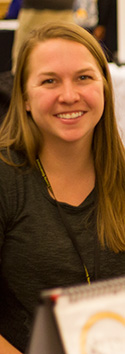 young woman with long honey blonde hair smiles at the camera