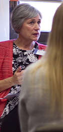 woman with short grey hair and colorful dress