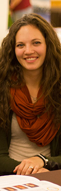 young woman with rust colored infinity scarf, long brown hair
