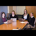 Four members of the Thomas Lab with their laptops open.