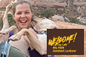 young woman holding large dog out in the wilderness