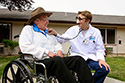 Male nursing student with stethescope and Groucho classes checks elderly patient with a smile