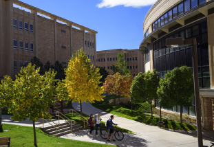 health sciences building with fall trees in front