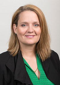 woman in black blazer and green blouse