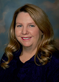 Woman with long wavy blonde hair in black sweater for portrait