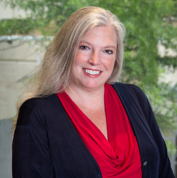 photo of faith jones in a red blouse and black sweater