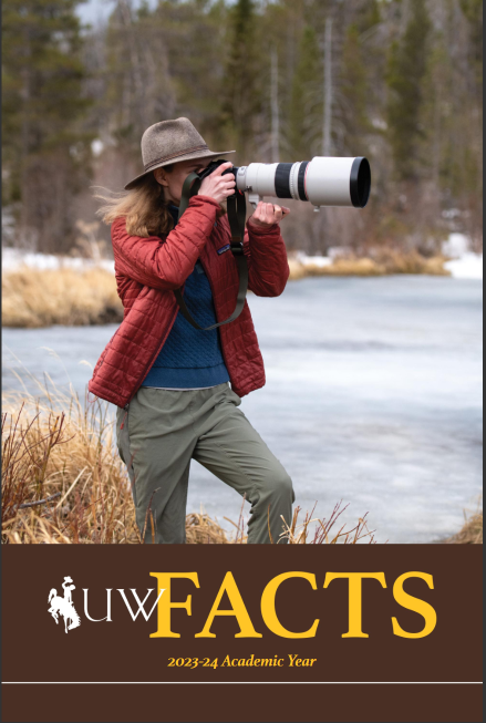 University of Wyoming Fact Book Cover - A student walks across campus in the fall.