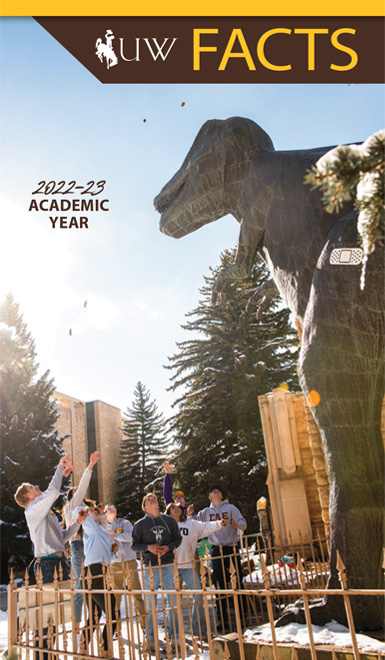 University of Wyoming Fact Book Cover - A student walks across campus in the fall.