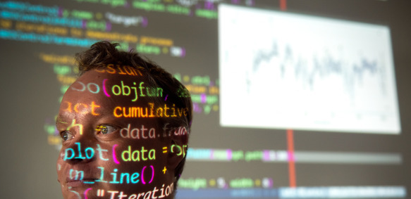 UW Student with coding highlighted across their face