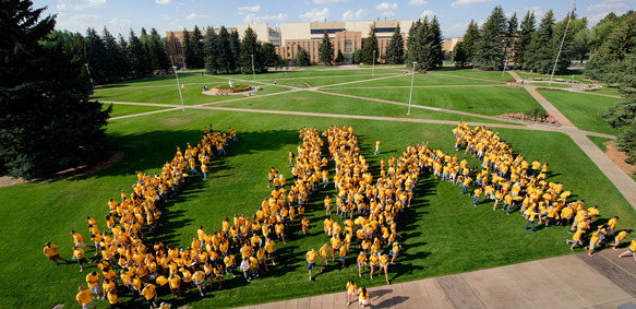 Image of new first-time full-time students spelling the letters UW on Prexies Pasture