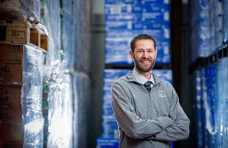 man poses in warehouse