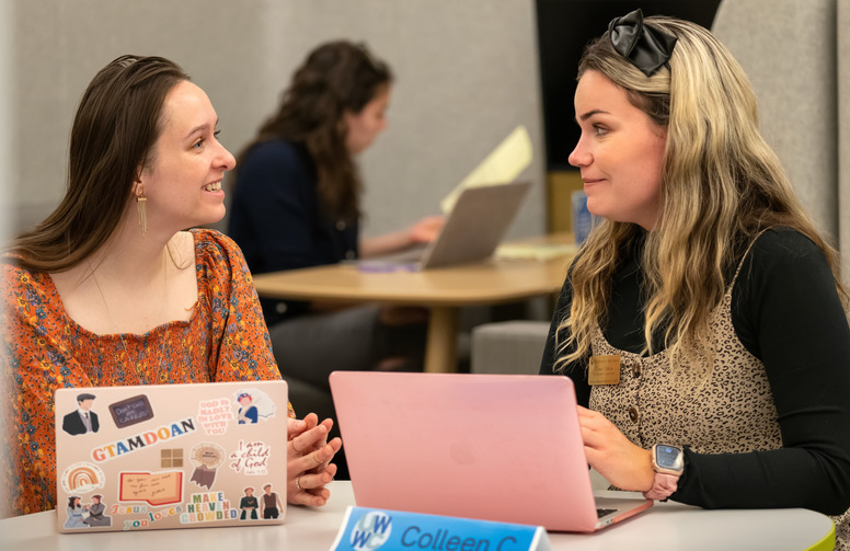 two women engage in a meeting