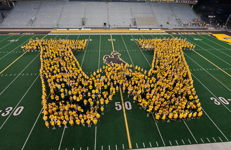 Students form a W in War Memorial Stadium