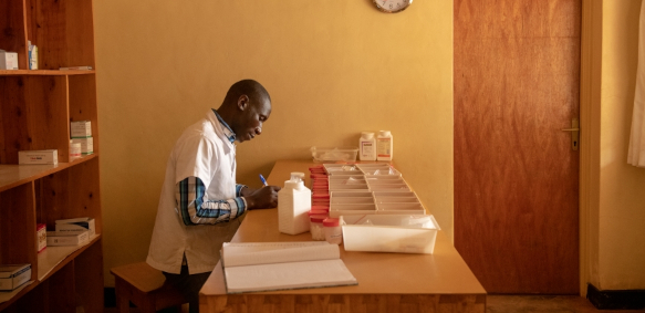A health worker sorting supplies in a pharmacy in Rwanda