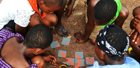 Girls solving a puzzle at a Girl Leading Our World camp in Ghana