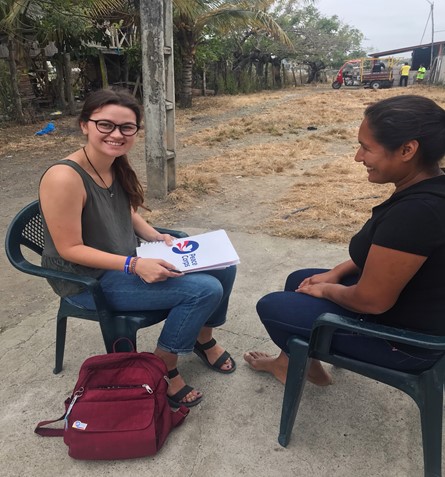 Katye Lester doing her site report with a community member