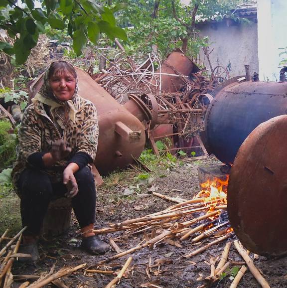 a woman in Moldova making raciu outside