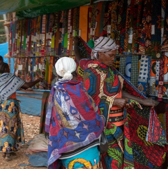 women standing at a fabric stall in Tanzania