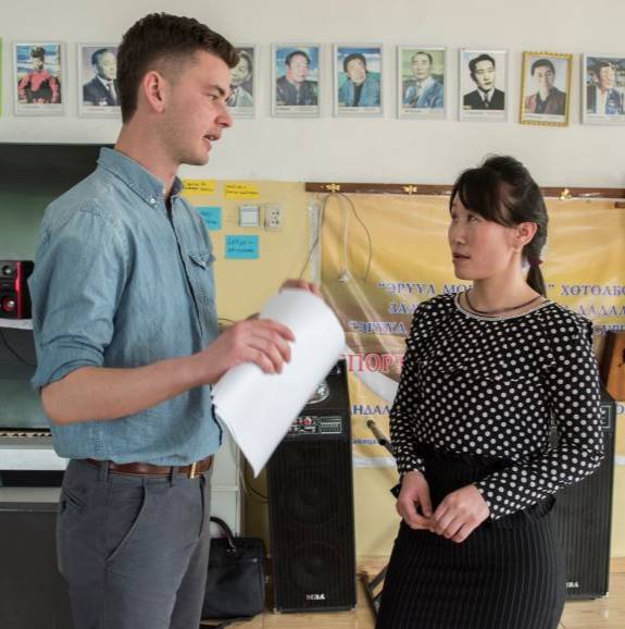 a pcv speaking with a teacher in Mongolia