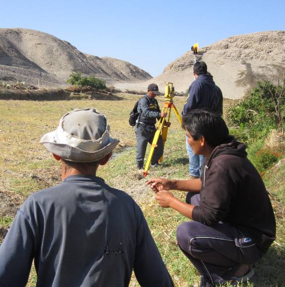pcv volunteers taking measurements for a sanitation project in Peru