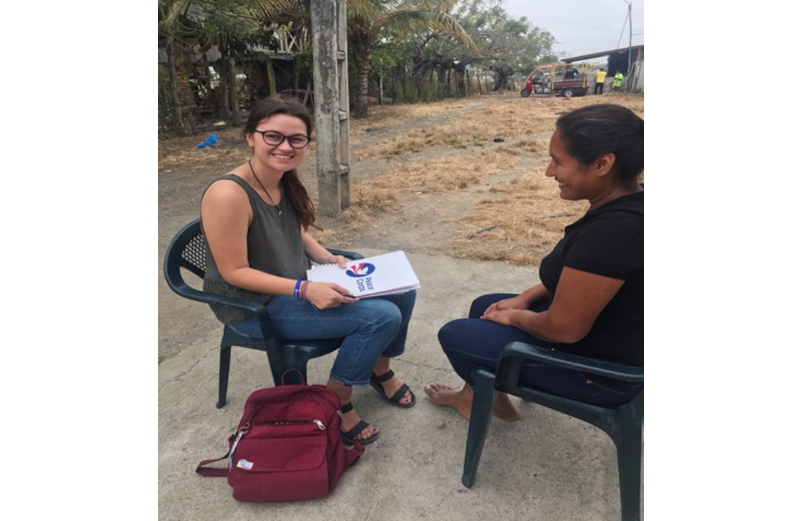 Kayte Lester sitting and speaking with a member of her volunteer community in Ecuador