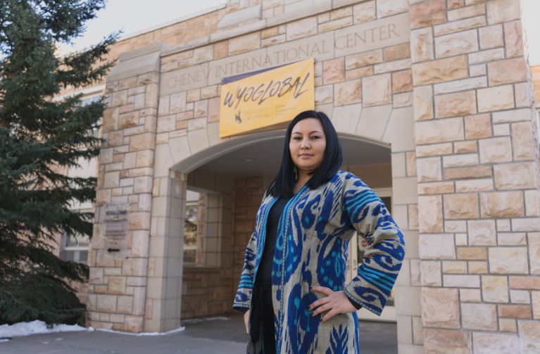 Picture of international students and scholars staff member outside the Cheney International Center building.
