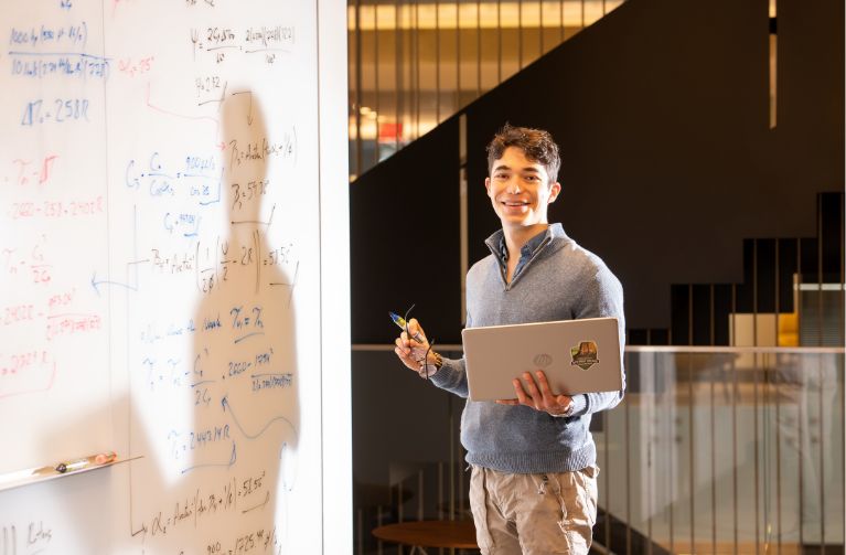Picture of a student with a textbook.