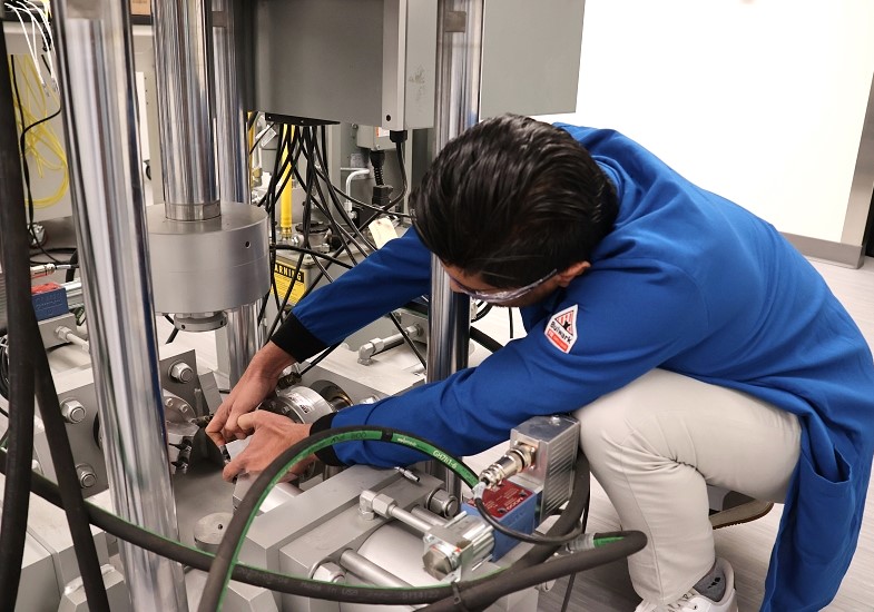 PhD student Ansar Usman working with the True Triaxial Testing unit
