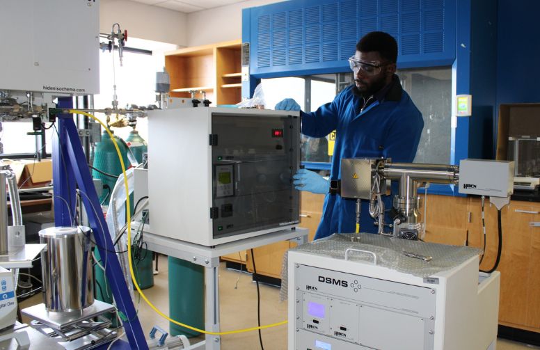 Picture of graduate student researcher in the phase behavior of nanoconfined fluids lab.