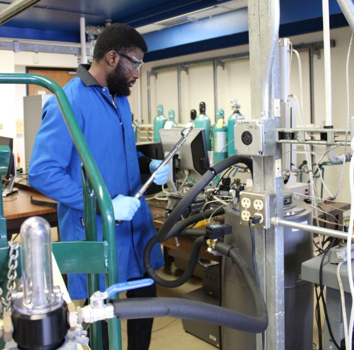 Picture of graduate research assistant in the phase behavior lab.